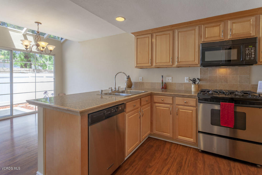 1990 Rory Lane, Unit 3 Simi Valley, CA 93063 - Photo 4 of 22 a kitchen with stainless steel appliances granite countertop a sink stove and microwave