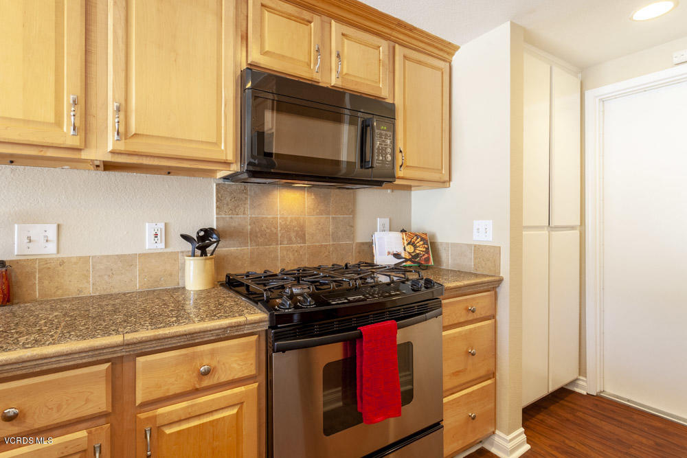1990 Rory Lane, Unit 3 Simi Valley, CA 93063 - Photo 5 of 22 a kitchen with stainless steel appliances granite countertop a stove and a microwave