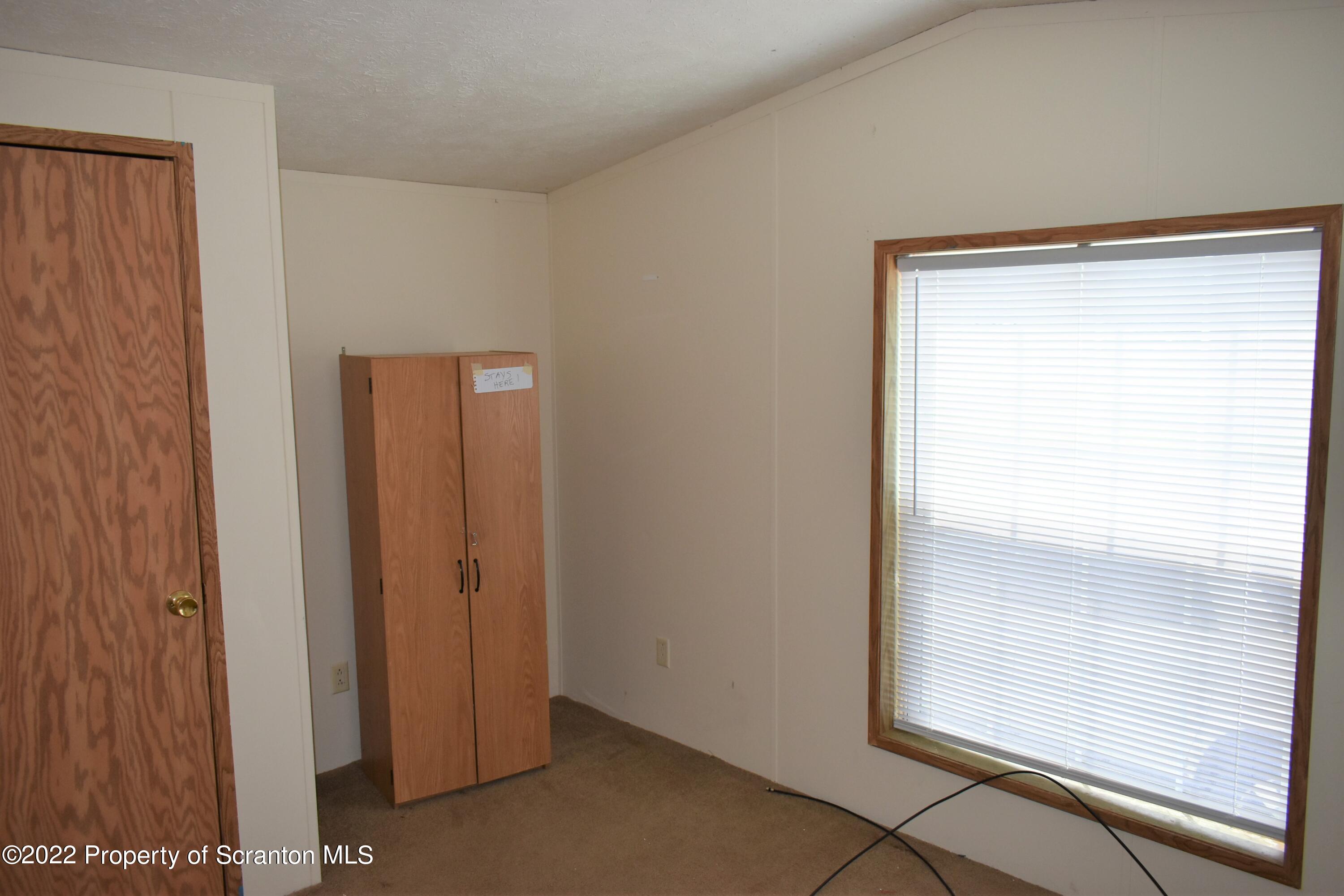 940 Nowlan Road Port Crane, NY 13833 - Photo 7 of 12 a view of an empty room and window
