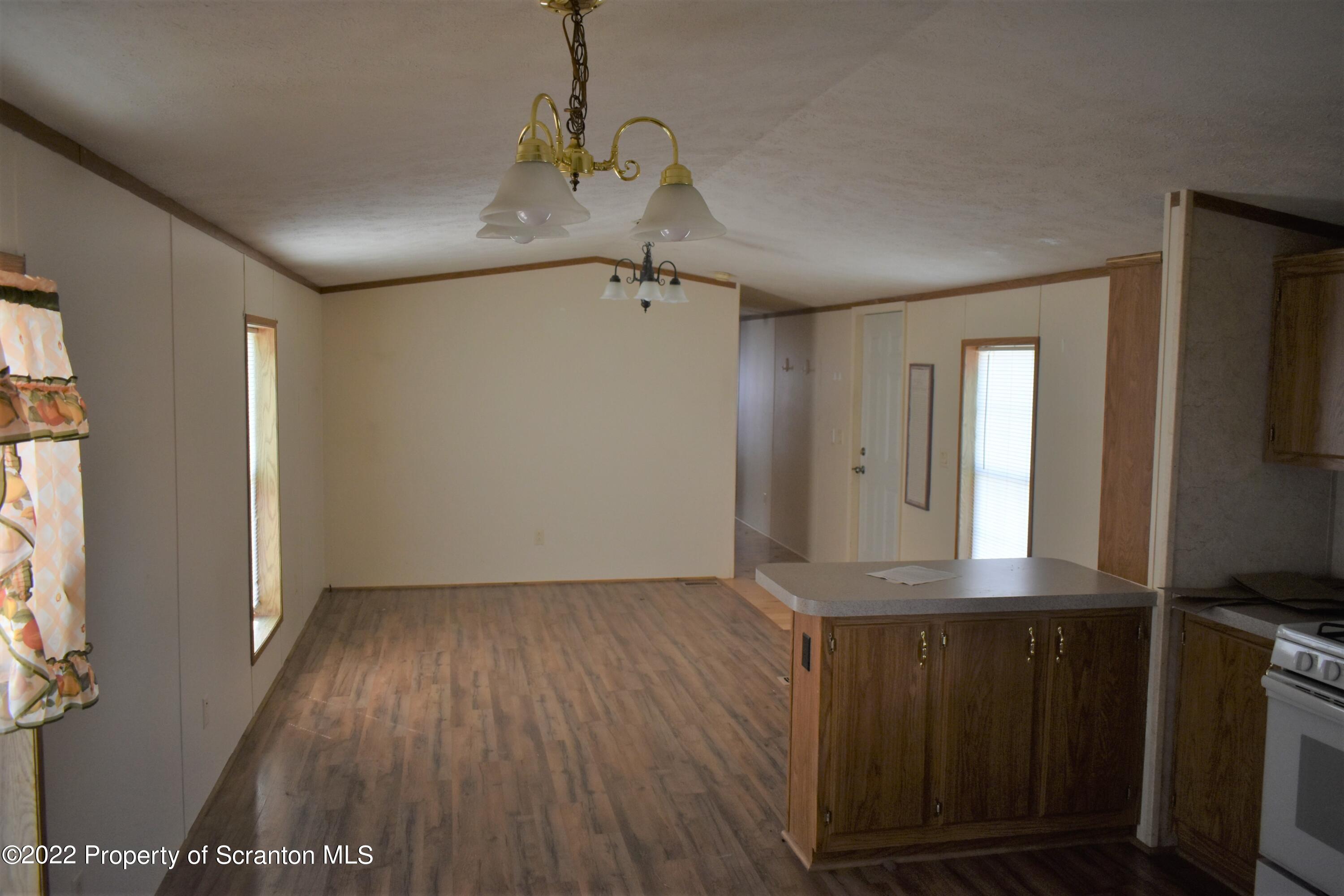 940 Nowlan Road Port Crane, NY 13833 - Photo 9 of 12 a view of a hallway with wooden floor and a bathroom