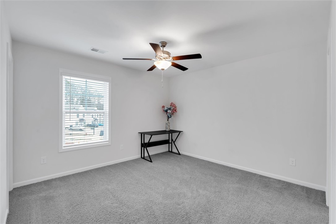 215 Royal Way Pendleton, SC 29670 - Photo 18 of 33 This bright room features a large window and soft carpeting, creating a comfortable living space.