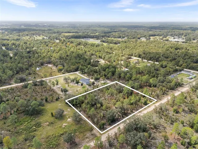 an aerial view of house with yard