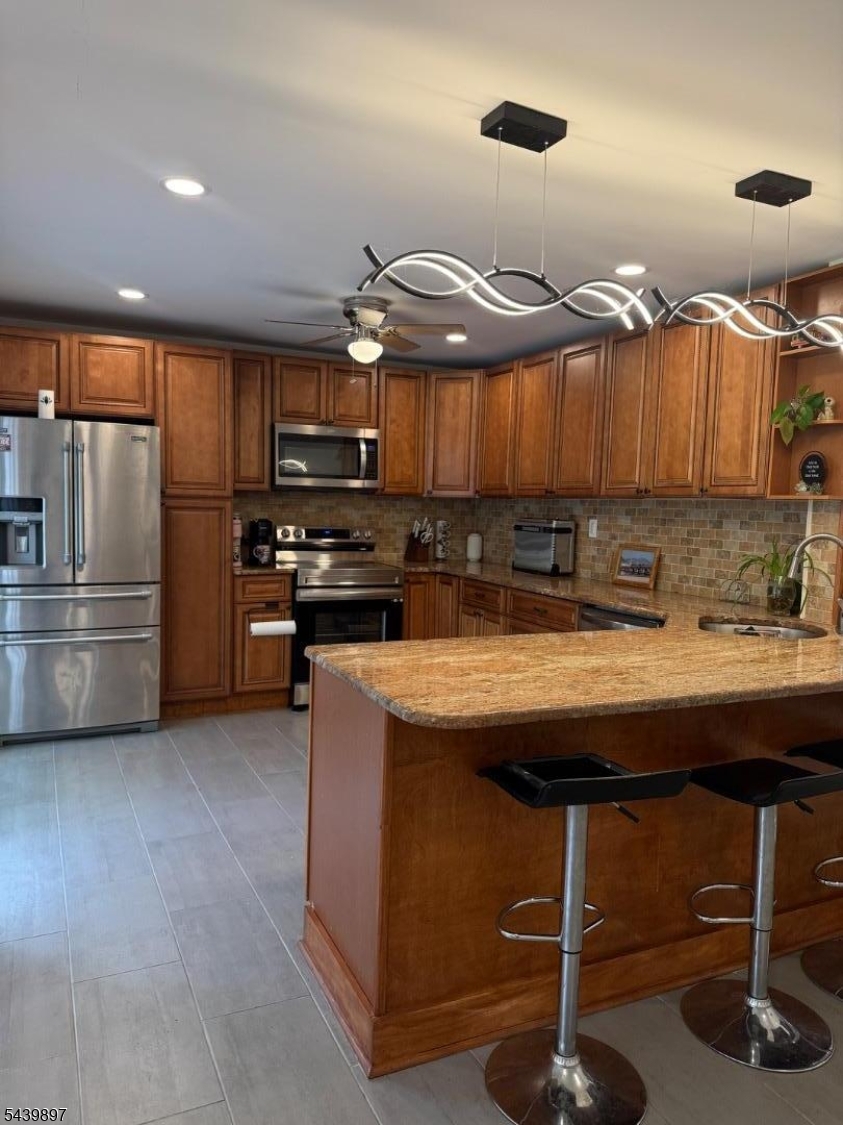 22 Karen Road Vernon, NJ 07422 - Photo 17 of 26 a kitchen with cabinets and stainless steel appliances