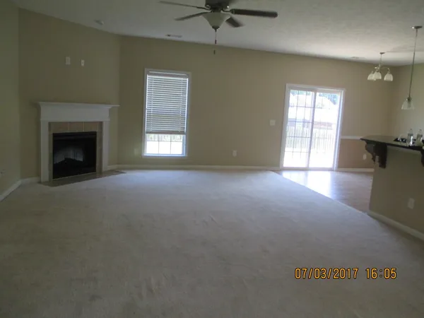a view of empty room with a fireplace
