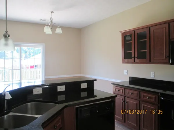 a kitchen that has a sink and cabinets