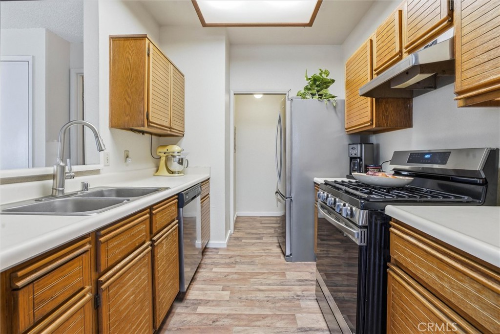 2483 Country Santa Maria, CA 93455 - Photo 7 of 19 a kitchen with stainless steel appliances granite countertop a sink stove and refrigerator
