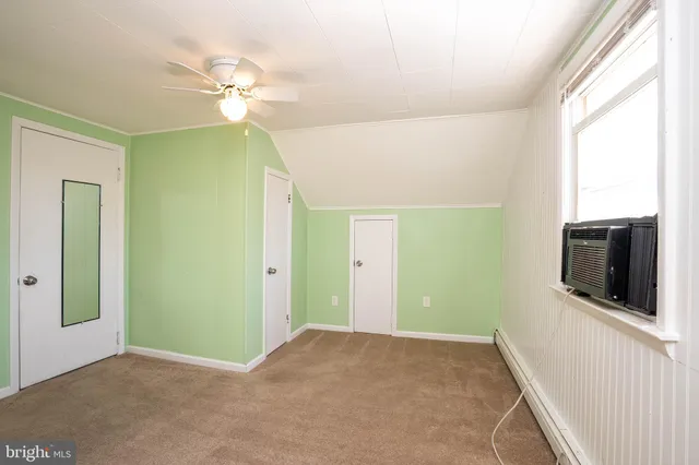 a view of a hallway with a flat screen tv