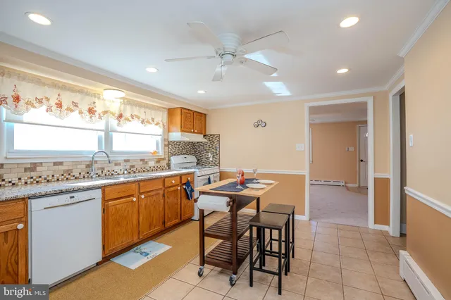 a kitchen with stainless steel appliances granite countertop a sink and a refrigerator