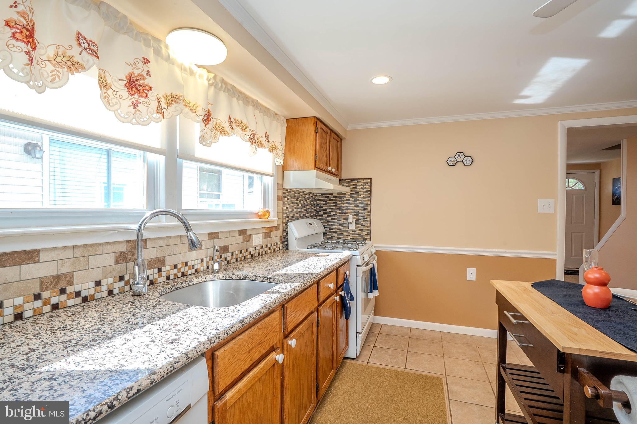 135 Keswick Avenue Ewing, NJ 08638 - Photo 7 of 22 a kitchen with granite countertop a sink and a stove