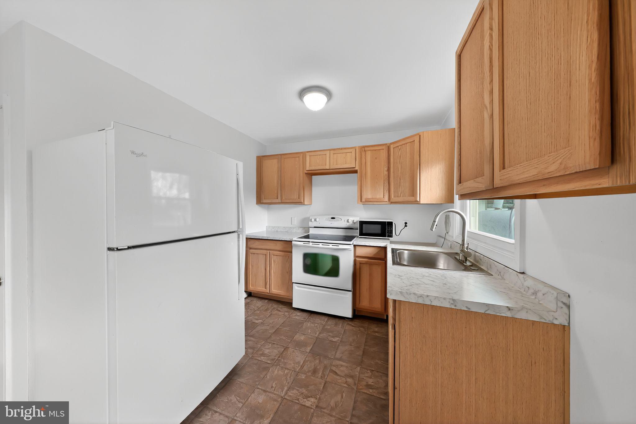 68 Saxton Road Dover, DE 19901 - Photo 10 of 24 a kitchen with stainless steel appliances granite countertop a refrigerator a stove a sink and a white cabinets
