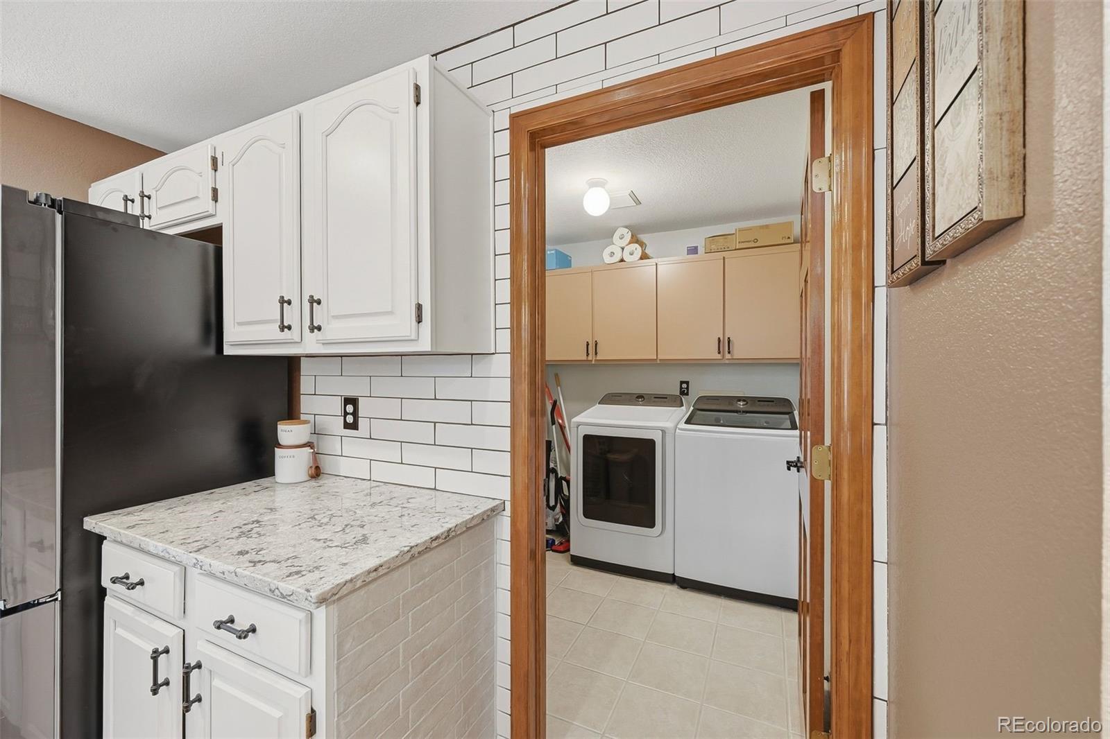 9372 Prairie View Drive Highlands Ranch, CO 80126 - Photo 11 of 50 a kitchen with a sink stove and refrigerator