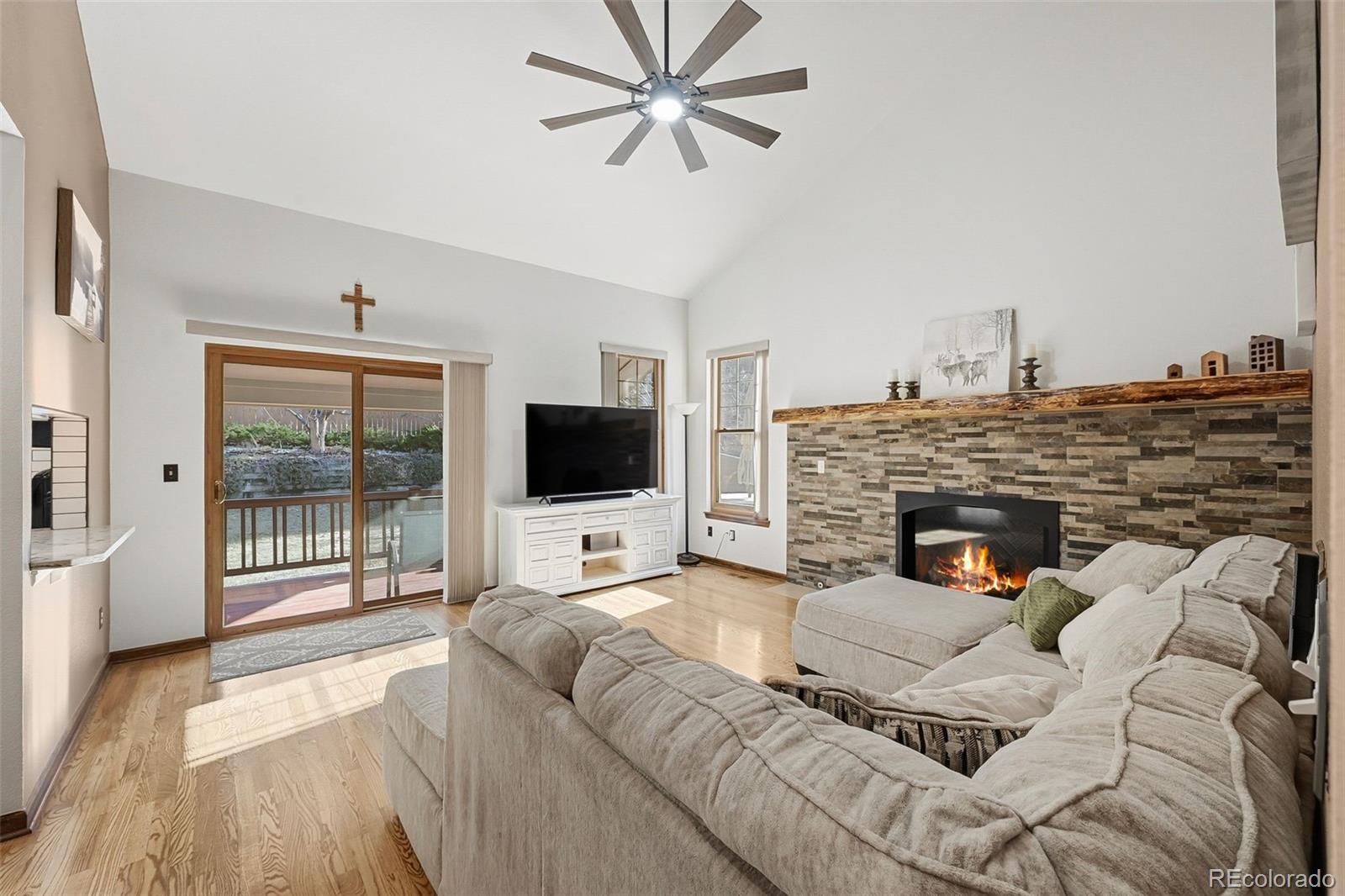 9372 Prairie View Drive Highlands Ranch, CO 80126 - Photo 16 of 50 a living room with furniture a flat screen tv and a fireplace