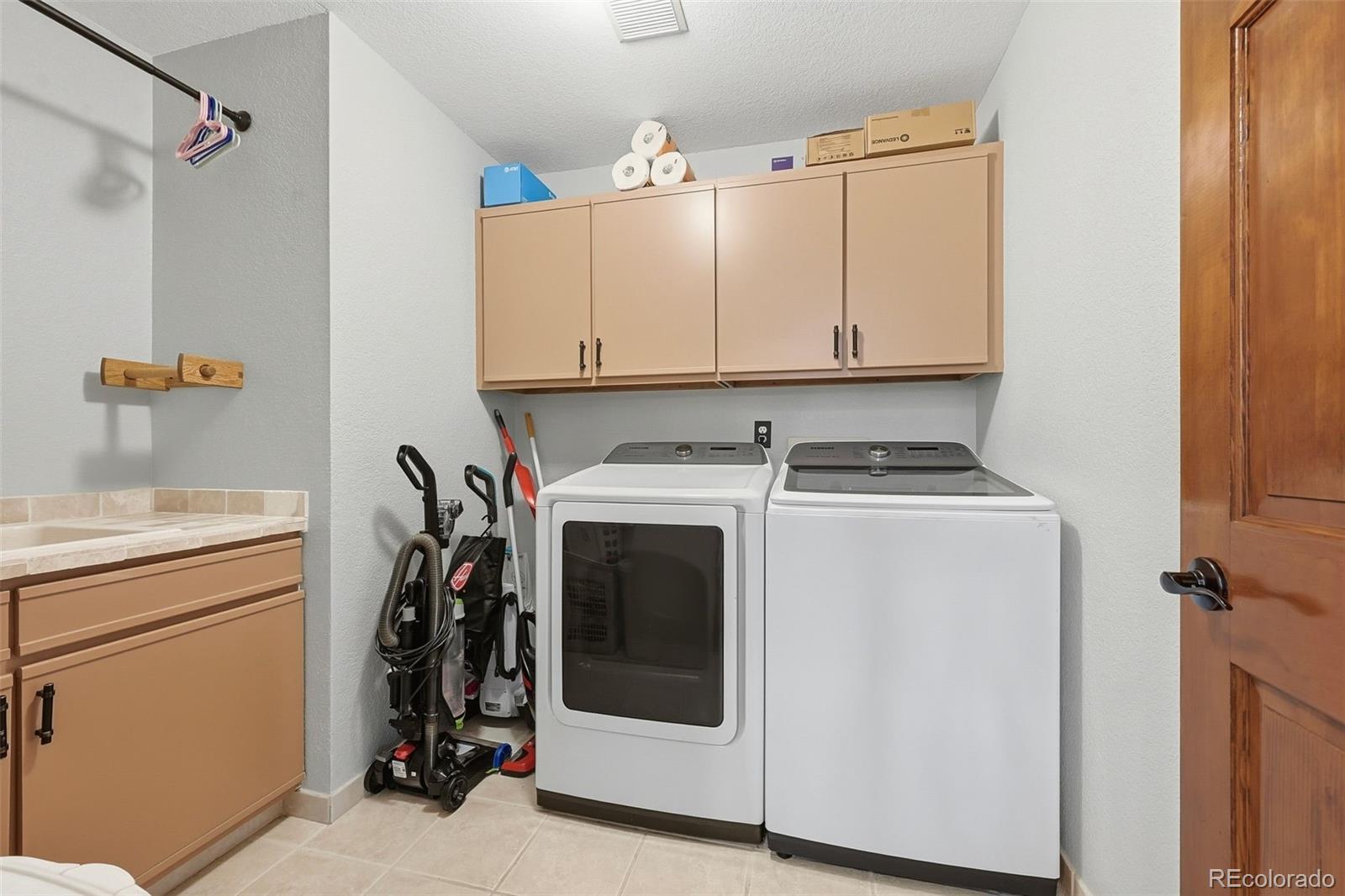 9372 Prairie View Drive Highlands Ranch, CO 80126 - Photo 17 of 50 a view of storage and utility room with washer and dryer