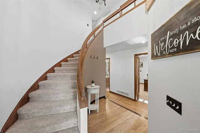 a bathroom with a granite countertop sink toilet a mirror and shower