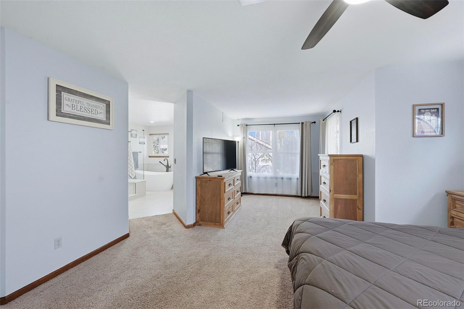 9372 Prairie View Drive Highlands Ranch, CO 80126 - Photo 27 of 50 a bedroom with a bed and furniture