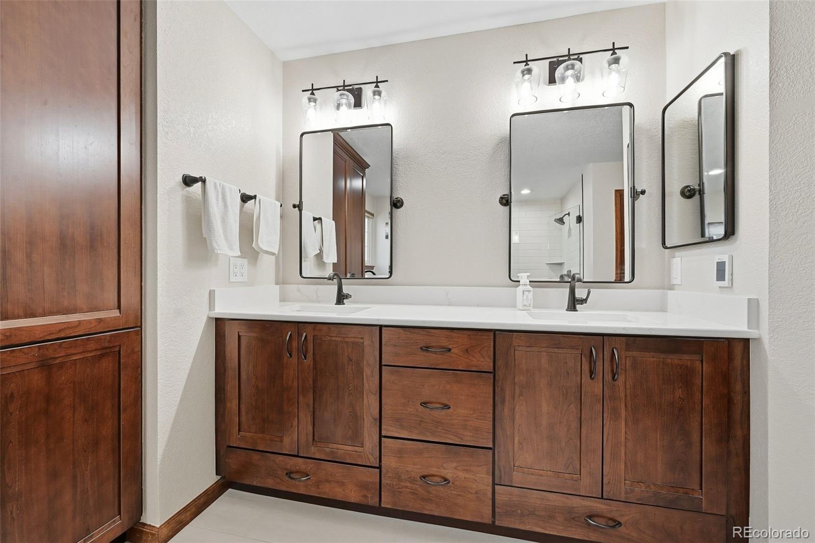 9372 Prairie View Drive Highlands Ranch, CO 80126 - Photo 29 of 50 a bathroom with a double vanity sink and a mirror