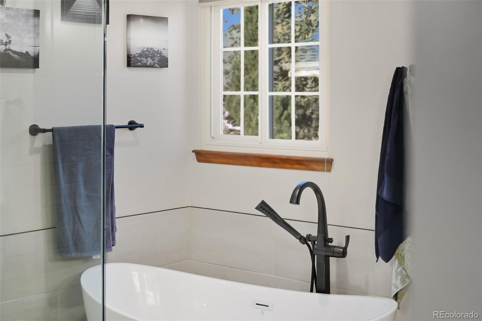 9372 Prairie View Drive Highlands Ranch, CO 80126 - Photo 30 of 50 a bathroom with a bathtub and a window