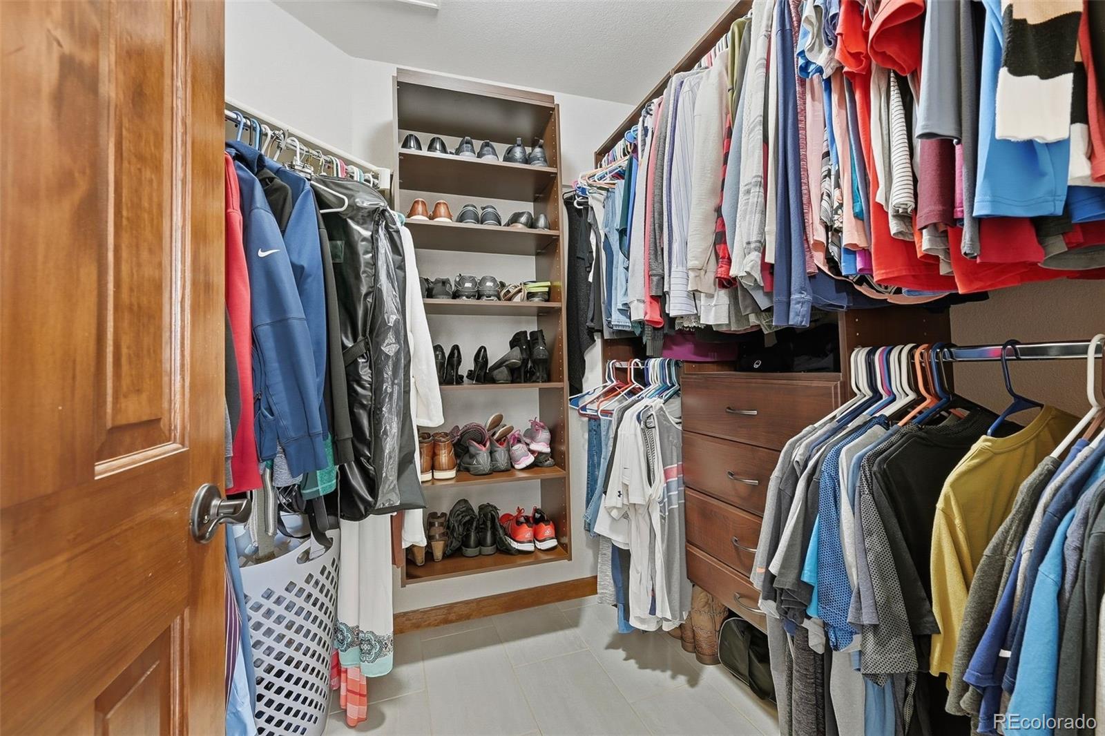 9372 Prairie View Drive Highlands Ranch, CO 80126 - Photo 31 of 50 a view of walk in closet with clothes and shoes