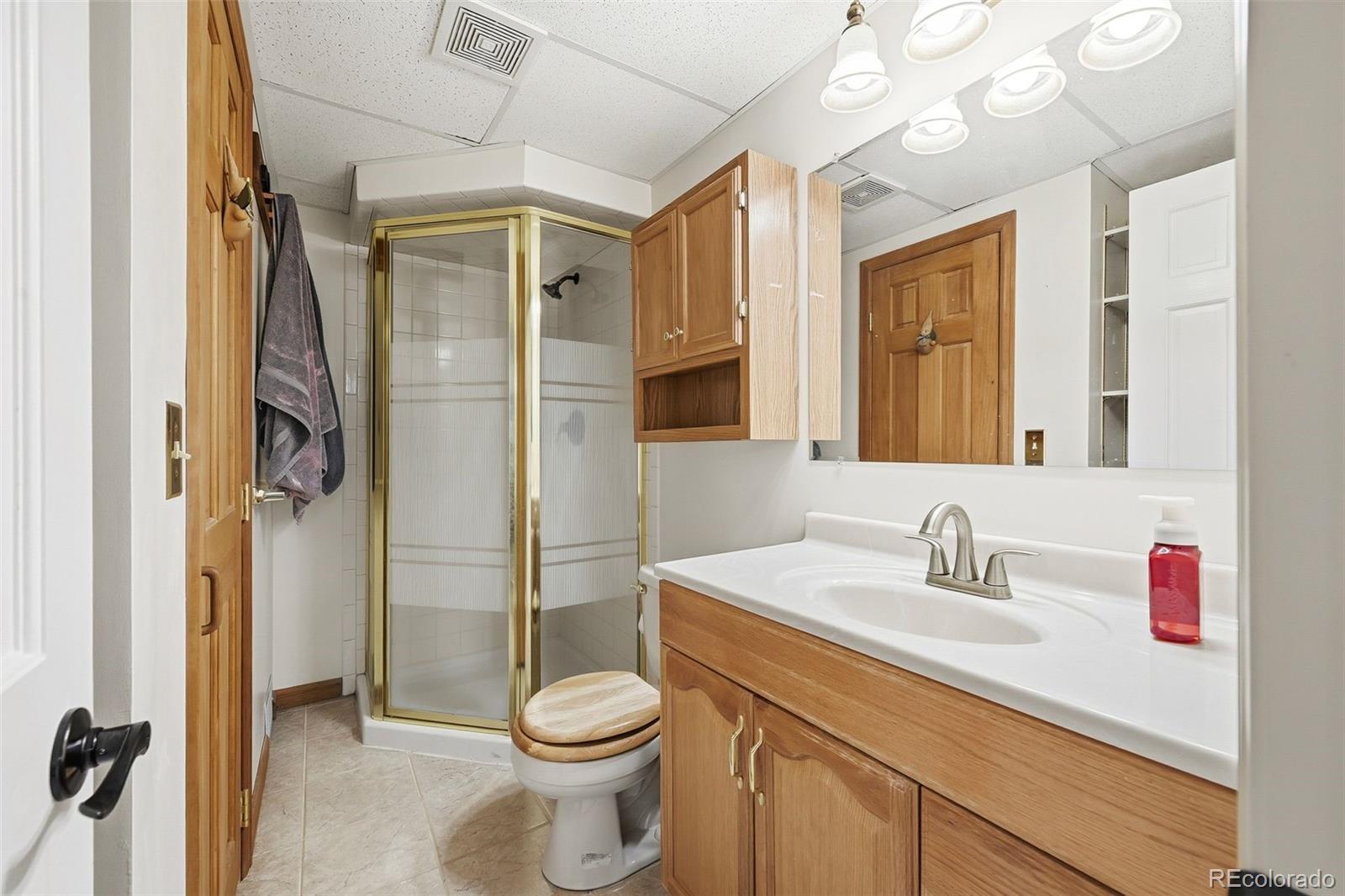 9372 Prairie View Drive Highlands Ranch, CO 80126 - Photo 38 of 50 a bathroom with a sink a toilet and shower