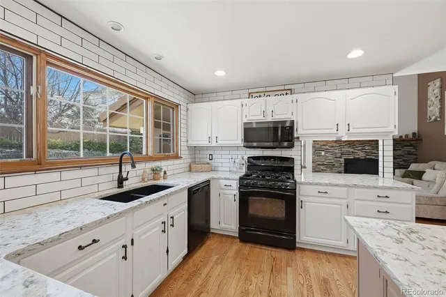 a kitchen with a sink stove and refrigerator