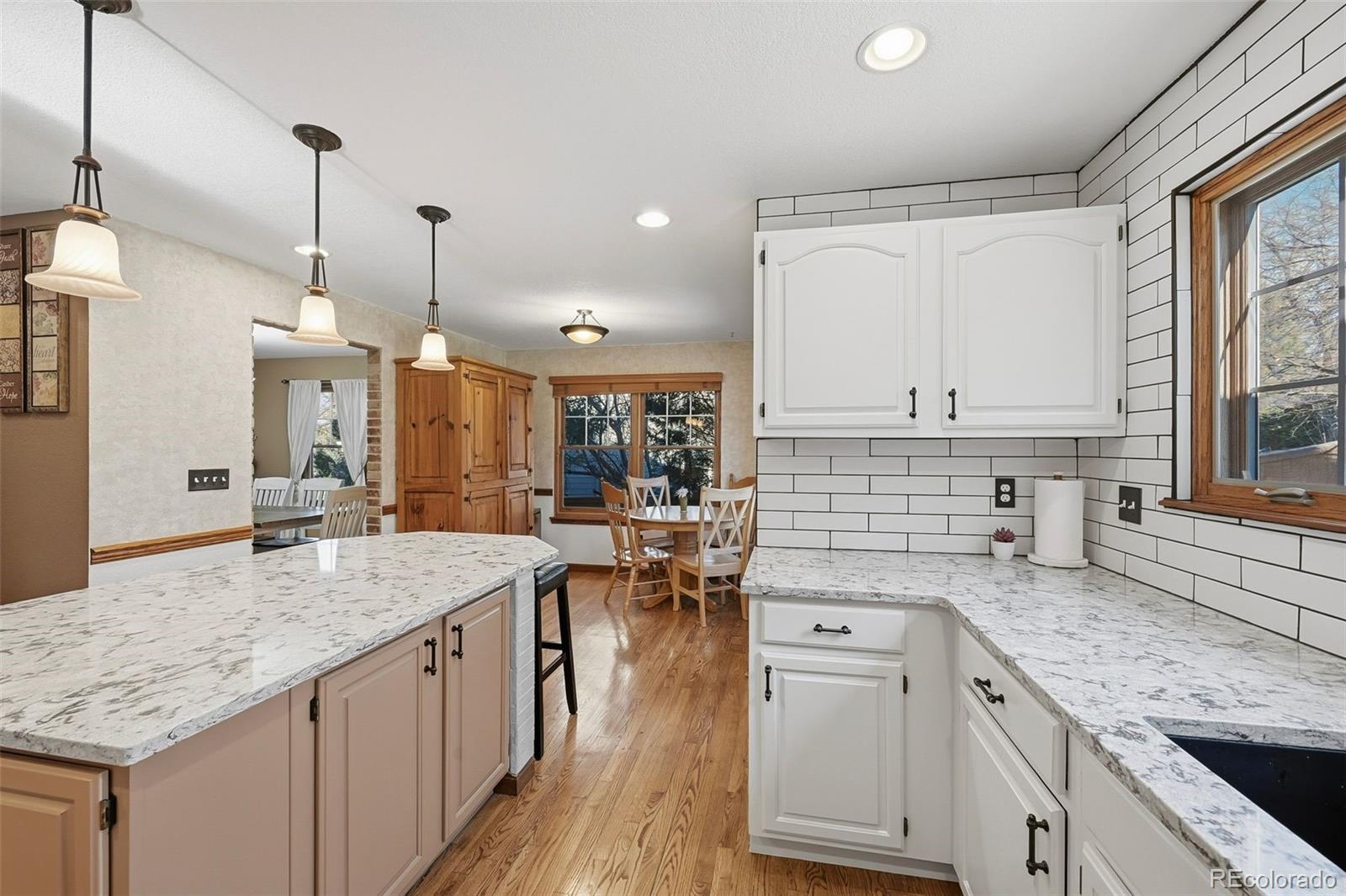 9372 Prairie View Drive Highlands Ranch, CO 80126 - Photo 6 of 50 a kitchen with stainless steel appliances granite countertop a sink stove and wooden floor
