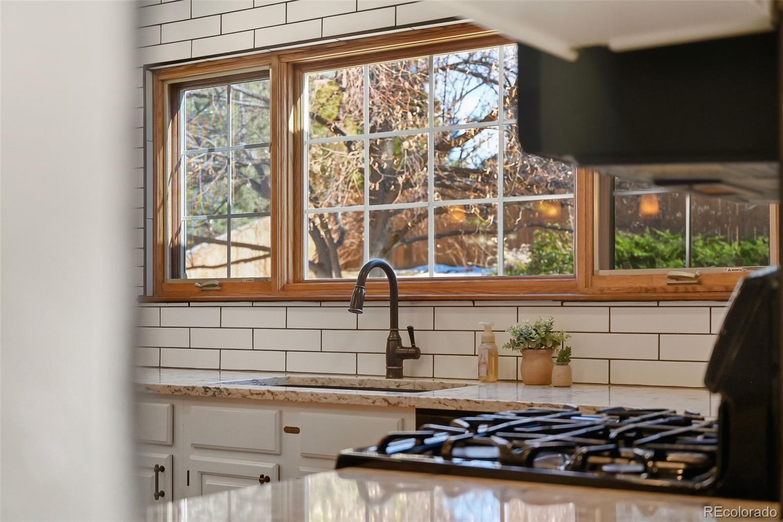 9372 Prairie View Drive Highlands Ranch, CO 80126 - Photo 9 of 50 a sink a stove and a window