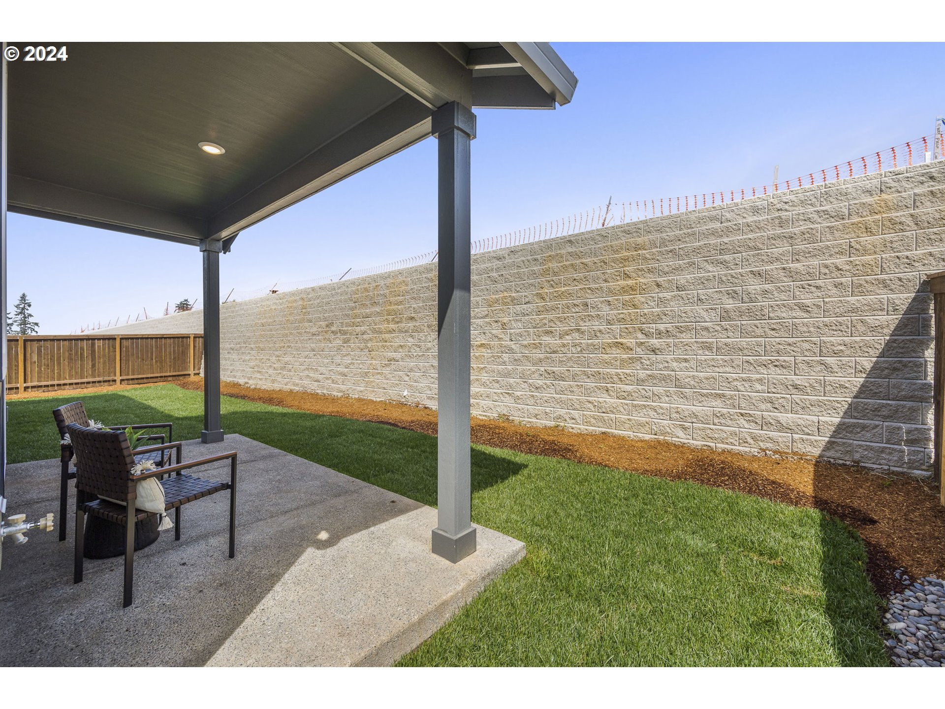 2735 South 9th Circle Ridgefield, WA 98642 - Photo 35 of 38 a view of a patio with a table and chairs next to an ocean