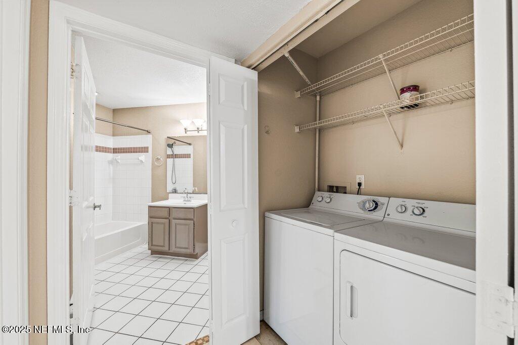 10150 Belle Rive Boulevard, Unit 303 Jacksonville, FL 32256 - Photo 10 of 23 a bathroom with a sink and mirror