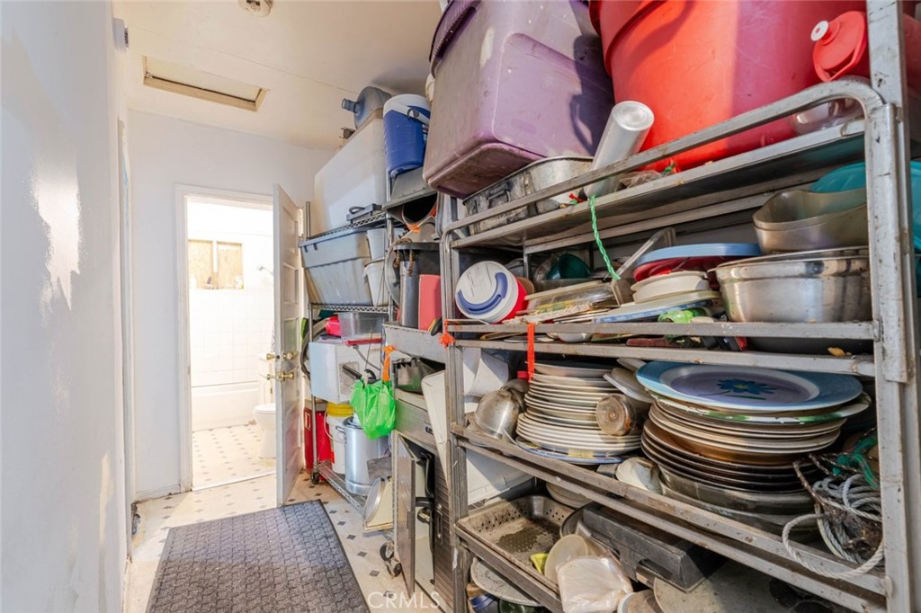 811 East 43rd Place Los Angeles, CA 90011 - Photo 12 of 31 a kitchen with a stove a microwave and a dining table