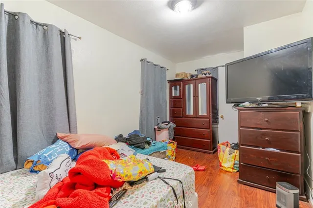 a bedroom with a bed and flat screen tv