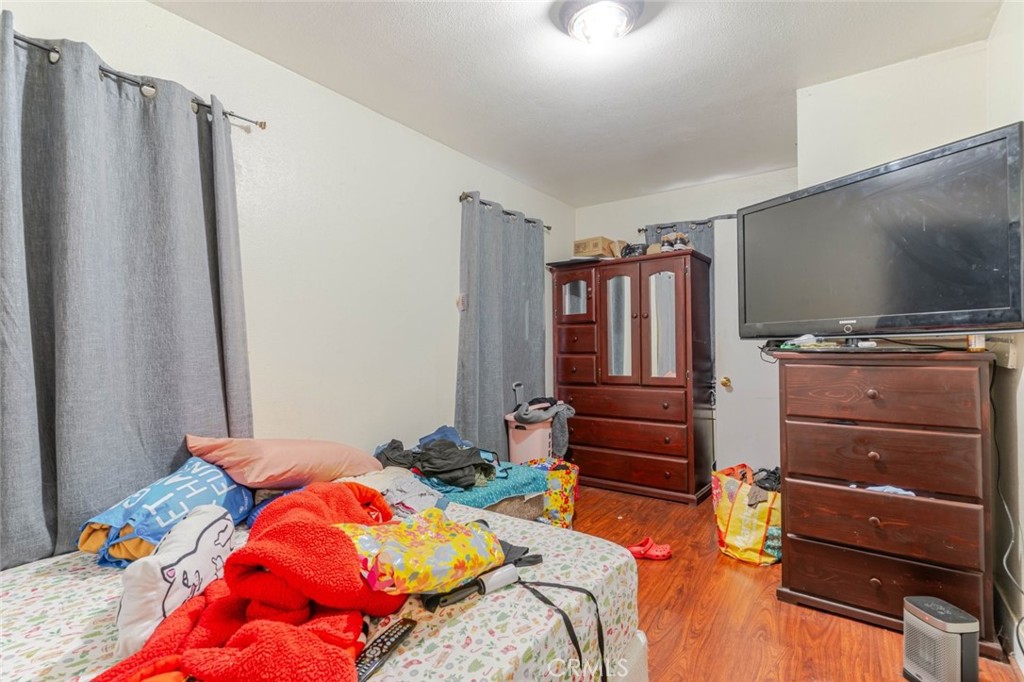 811 East 43rd Place Los Angeles, CA 90011 - Photo 14 of 31 a bedroom with a bed and flat screen tv