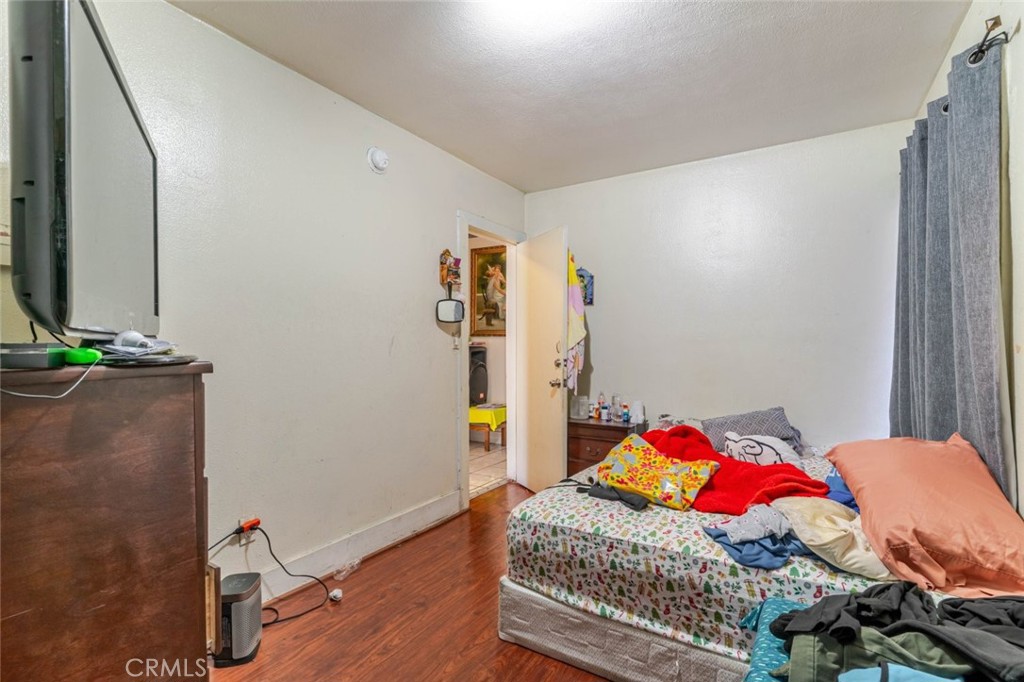811 East 43rd Place Los Angeles, CA 90011 - Photo 15 of 31 a bedroom with a bed and a dresser