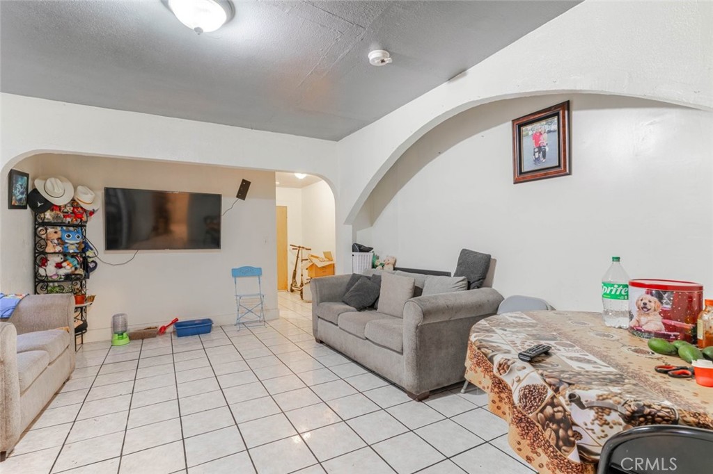 811 East 43rd Place Los Angeles, CA 90011 - Photo 18 of 31 a bedroom with furniture and a flat screen tv