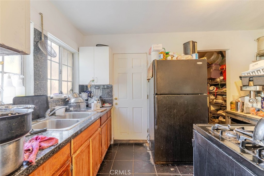 811 East 43rd Place Los Angeles, CA 90011 - Photo 7 of 31 a kitchen with stainless steel appliances granite countertop a refrigerator and a sink
