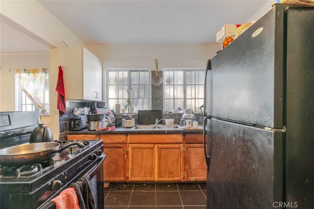 a kitchen with sink a refrigerator and a stove