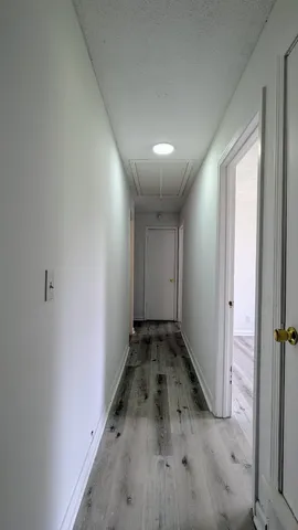 a view of a room with wooden floor