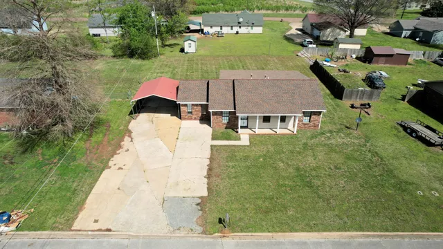 an aerial view of residential houses with outdoor space and parking