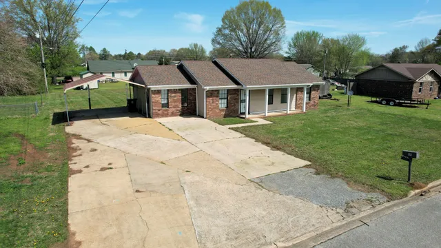 a aerial view of a house with a garden and trees