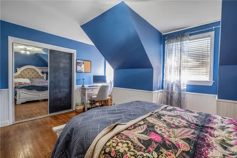 a bedroom with a bed and dresser