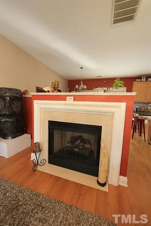a living room with a fireplace furniture and a wooden floor