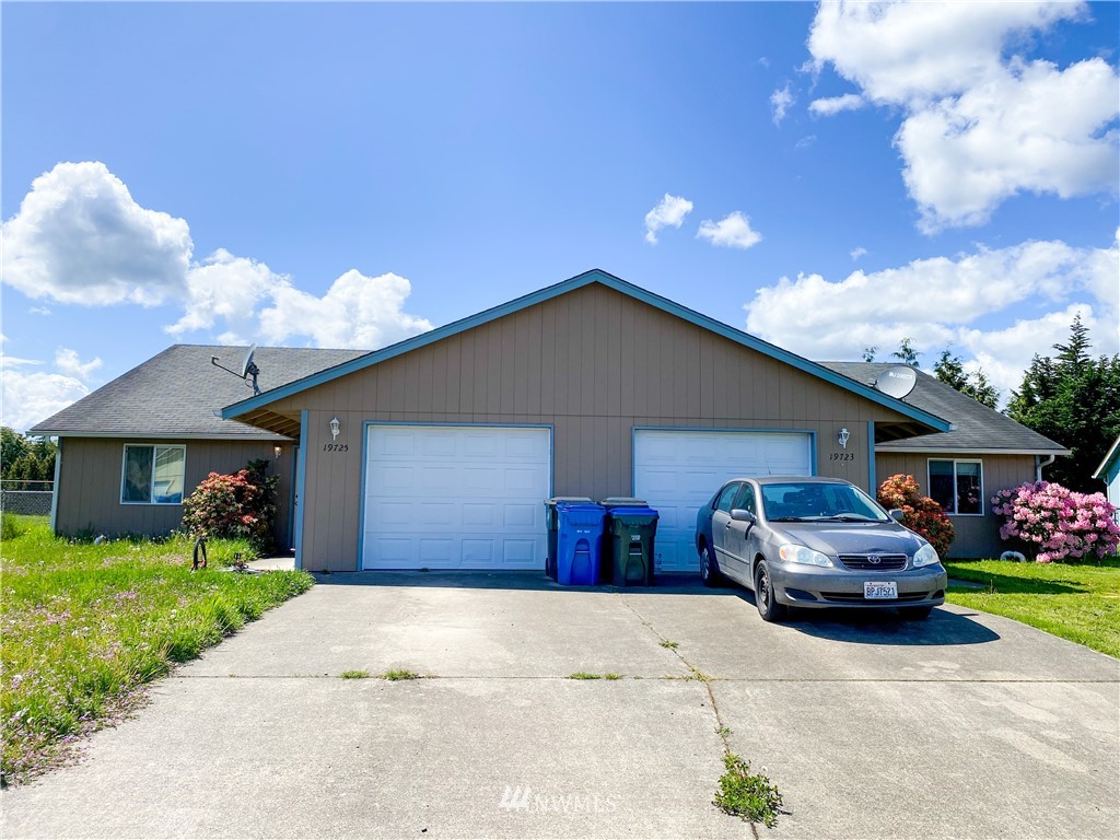 19723 Isabella Lane Southwest Rochester, WA 98579 - Photo 1 of 11 a front view of a house with a yard and garage
