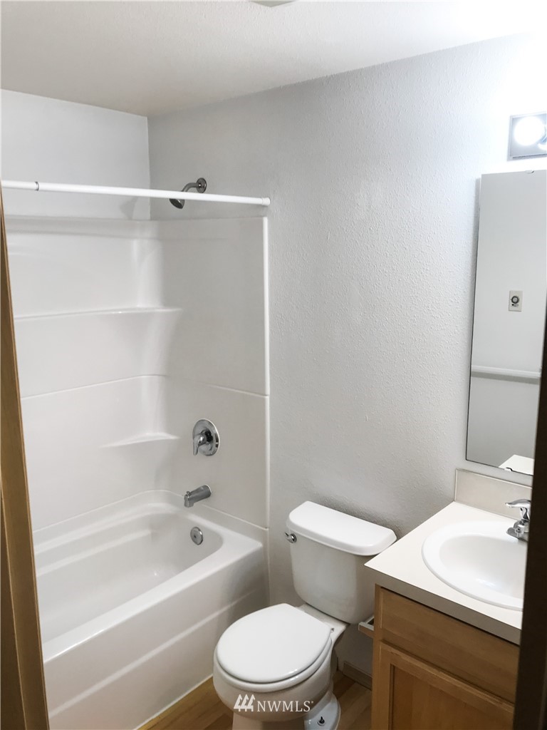 19723 Isabella Lane Southwest Rochester, WA 98579 - Photo 9 of 11 a bathroom with a sink a toilet a mirror and a shower