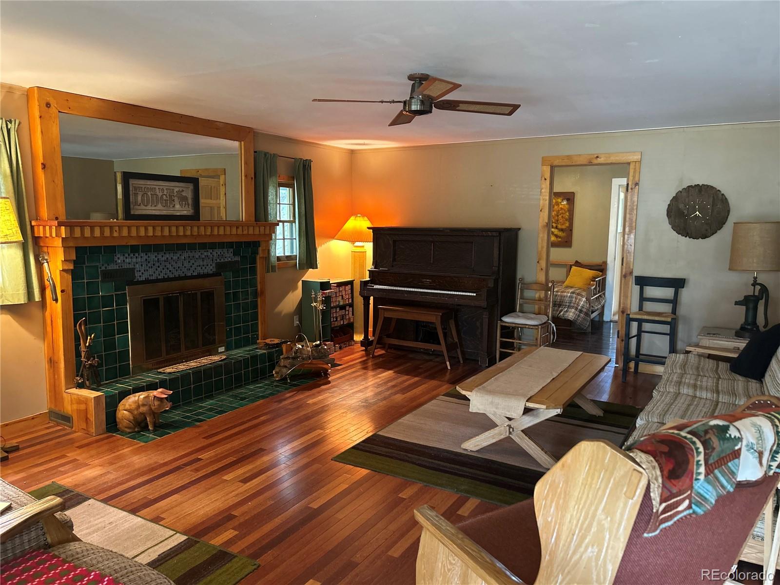 4393 South Pima Road Indian Hills, CO 80454 - Photo 4 of 12 a living room with furniture fireplace and a fireplace