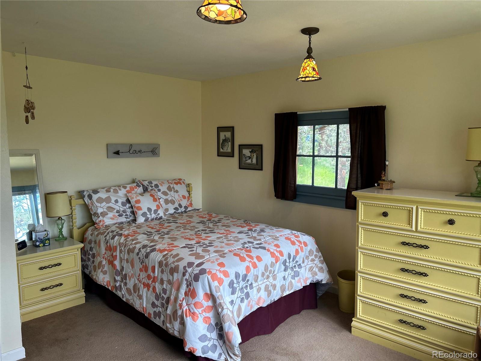 4393 South Pima Road Indian Hills, CO 80454 - Photo 8 of 12 a bedroom with a bed and a window