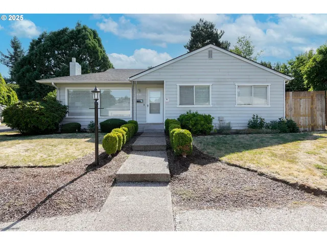 a front view of a house with garden