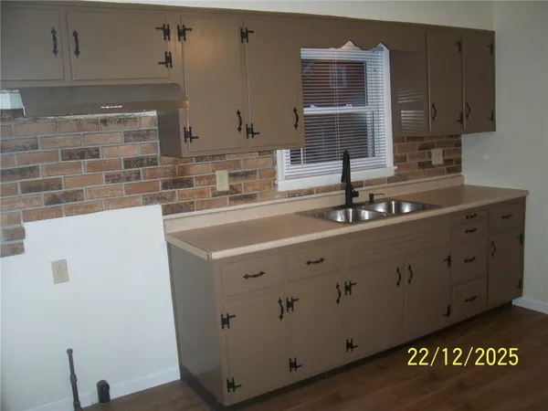a kitchen with a sink and cabinets
