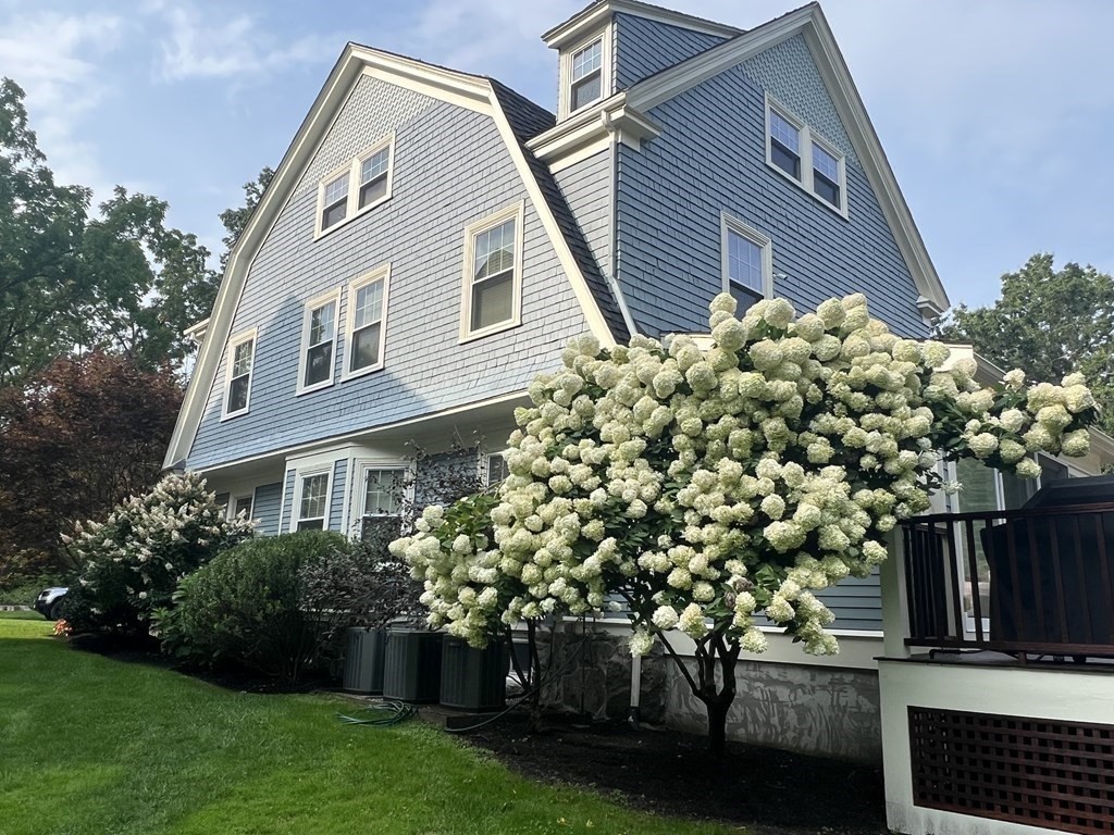 a front view of a house with a garden