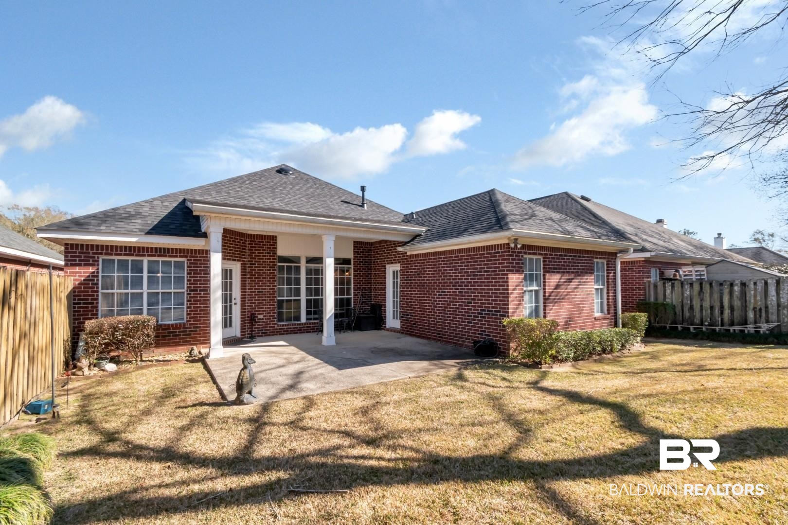 1032 Cross Gates Place Mobile, AL 36609 - Photo 30 of 34 Rear view of house featuring a fenced backyard, brick siding, a patio area, and roof with shingles