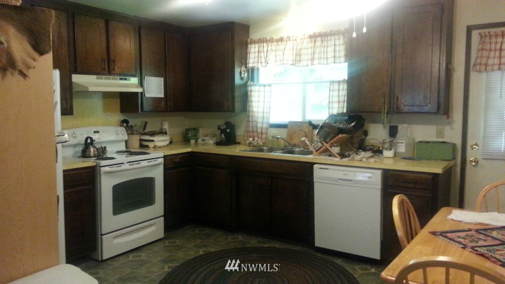 8440 178th Avenue Southwest Rochester, WA 98579 - Photo 7 of 15 a kitchen with a sink stove and cabinets