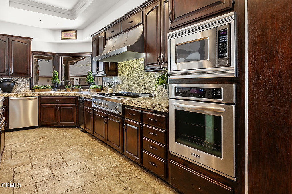 95 Avocado Place Camarillo, CA 93010 - Photo 13 of 74 a kitchen with stainless steel appliances granite countertop a stove microwave and cabinets